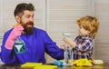 Father and son with cleaning supplies. Parents and child with rubber glove in foam. Cleaning family activities concept.