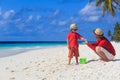 Father and son collecting shells on the beach Royalty Free Stock Photo