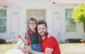 Father and son come back from school. Little schoolboy eating tasty lunch outdoors. Royalty Free Stock Photo