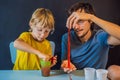 Father and son conduct chemical experiments at home. Home made slime. Family plays with a slime