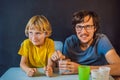 Father and son conduct chemical experiments at home. Home made slime