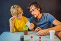 Father and son conduct chemical experiments at home. Home made slime