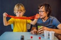 Father and son conduct chemical experiments at home. Home made slime. Family plays with a slime