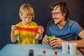 Father and son conduct chemical experiments at home. Home made slime. Family plays with a slime