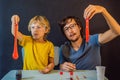 Father and son conduct chemical experiments at home. Home made slime. Family plays with a slime