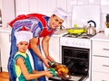 Father and son cooking chicken at kitchen Royalty Free Stock Photo