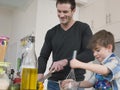 Father And Son Cooking Food In Kitchen Royalty Free Stock Photo