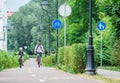 Father and son cycling on the bike road with blue road sign or signal of bicycle lane Royalty Free Stock Photo