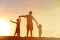 Father with son and daughter silhouettes play at sunset Royalty Free Stock Photo