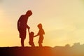 Father with son and daughter silhouettes play at sunset Royalty Free Stock Photo