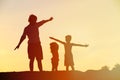 Father with son and daughter silhouettes play at sunset Royalty Free Stock Photo