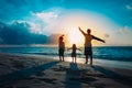 Father with son and daughter silhouettes play at sunset beach Royalty Free Stock Photo