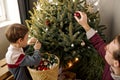 Father and son decorating Christmas tree. Funny family at home in living room. Royalty Free Stock Photo
