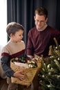 father and son decorating Christmas tree. Funny family at home in living room. Royalty Free Stock Photo