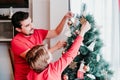 father and son decorating christmas tree at home Royalty Free Stock Photo