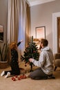 Father and son decorating Christmas tree in living room Royalty Free Stock Photo