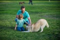 Father and son with dog on nature. Concept of friendly family with dog. Child with pet friend. Royalty Free Stock Photo