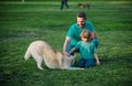 Father and son with dog on nature. Concept of friendly family with dog. Child with pet friend. Royalty Free Stock Photo