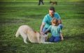 Father and son with dog on nature. Concept of friendly family with dog. Child with pet friend. Royalty Free Stock Photo