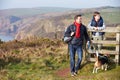 Father And Son With Dog Walking Along Coastal Path Royalty Free Stock Photo