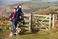 Father And Son With Dog Walking Along Coastal Path Royalty Free Stock Photo