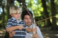 Father and son doing archery