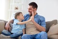 Father and son doing high five at home Royalty Free Stock Photo