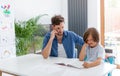 Father and son doing homework together Royalty Free Stock Photo