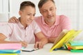 Father and son doing homework together at home Royalty Free Stock Photo