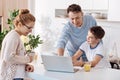 Father and son doing homework together in the kitchen Royalty Free Stock Photo