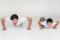 father and son doing push ups together Royalty Free Stock Photo