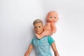 Father and son, dolls on a white background, father holds son in his arms, feeds his son. Caring for the family