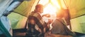 Father and son drink hot tea sitting together in camping tent Royalty Free Stock Photo