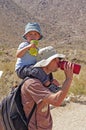 Father and Son drinking water while hiking