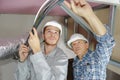 Father and son electricians working on buildings ceiling Royalty Free Stock Photo