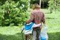 Father and son embracing in park picking up trash in nature together