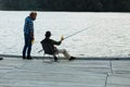 Father and son enjoying evening while fishing near river Royalty Free Stock Photo