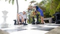 Father and son enjoying lifesize chess game Royalty Free Stock Photo