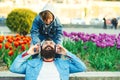 Father and son enjoying music outdoors. Young father using wireless headphones listen music