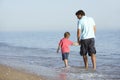 Father And Son Enjoying Walk Along Beach Royalty Free Stock Photo