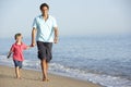 Father And Son Enjoying Walk Along Beach Royalty Free Stock Photo