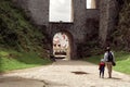 Father and son entering the medieval town Cesky Krumlov from the old arc.