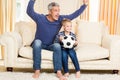 Father and son exulting on the sofa Royalty Free Stock Photo