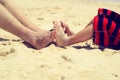 Father and son feet on summer beach