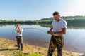 Father and son fishing on the lake together. Royalty Free Stock Photo