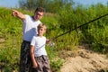 Father and son fishing on the lake together. Royalty Free Stock Photo