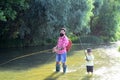 Father and son fishing. Father and son relaxing together. Little boy fishing with father.