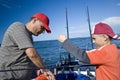 Father and son fishing at sea