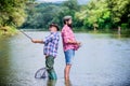 Father and son fishing. Summer weekend. Peaceful activity. Nice catch. Rod and tackle. Fisherman fishing equipment Royalty Free Stock Photo
