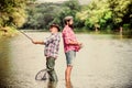 Father and son fishing. Summer weekend. Peaceful activity. Nice catch. Rod and tackle. Fisherman fishing equipment Royalty Free Stock Photo